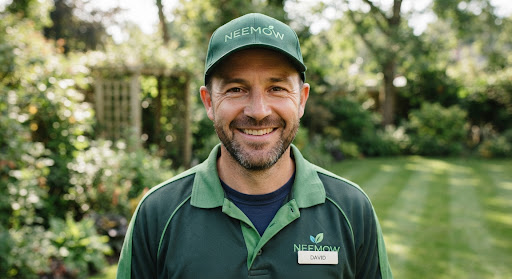 Close-up portrait of a friendly professional landscaper wearing clean work cap and green trim uniform