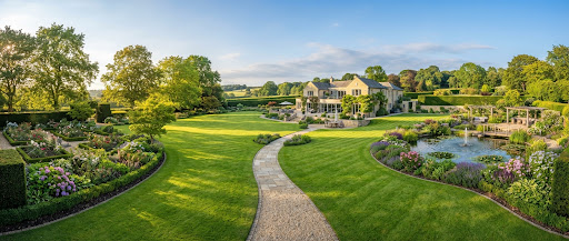 Panoramic wide angle view of an immaculate manicured residential garden estate with vibrant emerald grass