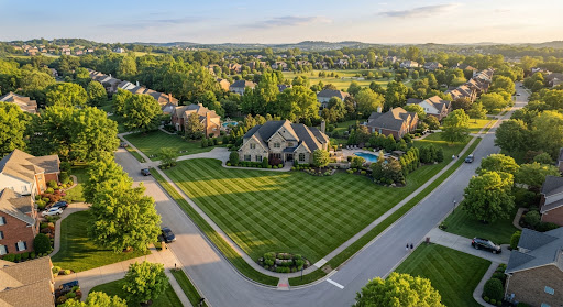 Stunning aerial high angle view of an immaculate residential lawn with clean cross-hatch mower stripes